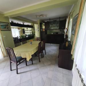 a dining room and kitchen with a table and chairs at Apartments Piglić in Lovran