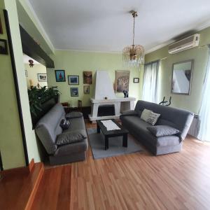 a living room with two couches and a fireplace at Apartments Piglić in Lovran