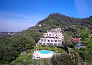 an aerial view of a large building on a mountain at CapoSperone Resort in Palmi