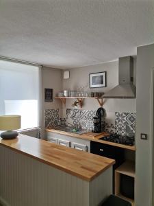 a kitchen with a wooden counter top and a stove at Appartement Aline et Phil in Luz-Saint-Sauveur