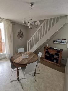 a dining room with a table and a staircase at Appartement Aline et Phil in Luz-Saint-Sauveur