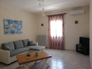 a living room with a couch and a coffee table at Sofirene Sea Scape in Batsi