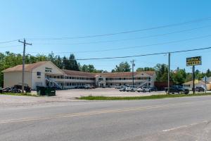 an empty parking lot in front of a building at Willabee's Motel in Brimley