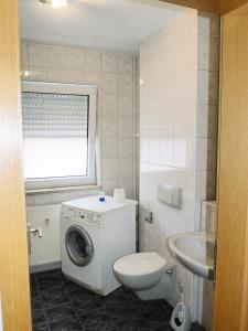 a bathroom with a washing machine and a toilet at Schöne Wohnung in Fürth