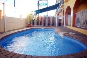 a swimming pool in the middle of a building at Cedar Lodge Motel in Townsville