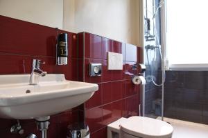 a bathroom with a sink and a toilet at Base Apartments in Hamburg +13 photos