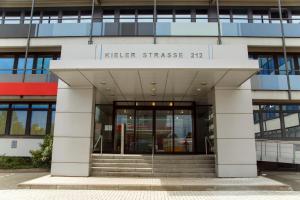 a building with the entrance to aigerstrasse at Base Apartments in Hamburg