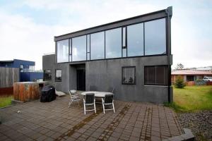 a house with a table and chairs in front of it at Sunny and Spacious Luxury House in Reykjavík