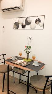 a dining room table with two chairs and a table with glasses at Apartament Colosseum view in Pula