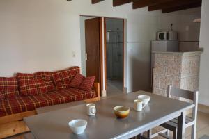 a living room with a table and a couch at Alizés in Saint-Denis-dʼOléron