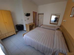 Postel nebo postele na pokoji v ubytování Hotel Vittoria
