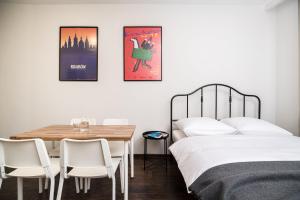 a bedroom with two beds and a table and chairs at Native Apartments Lubelska 14 in Krakow