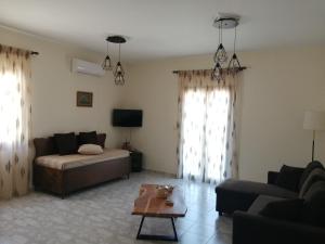 a living room with a couch and a table at Sofirene Sea View in Batsi
