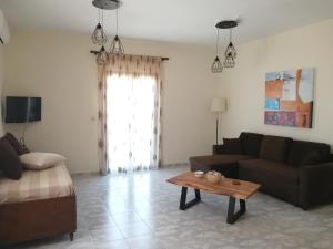 a living room with a couch and a coffee table at Sofirene Sea View in Batsi