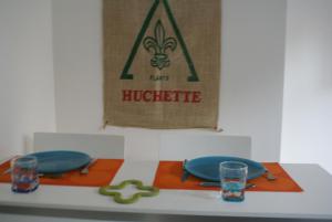 a table with two blue plates and glasses on it at La Cour Soubespin in Lille