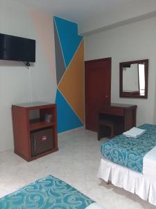 Ein Bett oder Betten in einem Zimmer der Unterkunft Hotel El Andino
