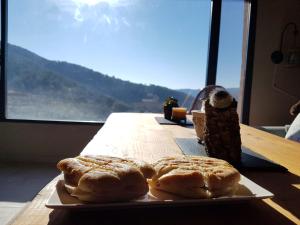 a plate of pastries on a table with a view at La Chocita de Tio Castor in Ovejuela