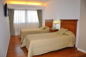 Een bed of bedden in een kamer bij Gran Hotel Guarani