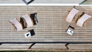 a group of chairs on a wooden wall at Hortas do Rio - Casa de Campo in Carrapateira