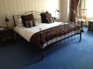 a bedroom with a large bed in a room at Grovefield Manor in Poole
