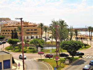 a city street with palm trees and a building at Residencial Toboso LEK in Peniscola