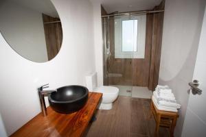 a bathroom with a black sink and a toilet at Agroturismo Basitegi in Urnieta +48 photos