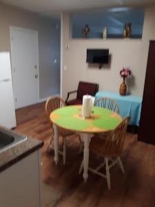 a kitchen and dining room with a table and chairs at Northern Peaks Motor Inn in Gorham