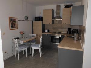 a kitchen with a table and a table and chairs at Haus Astrid -Schwerin-Görries - in Klein Rogahn