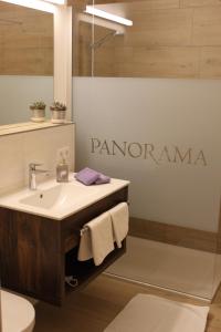 a bathroom with a sink and a sign that reads panoramic at Apartment Panorama in Wagrain