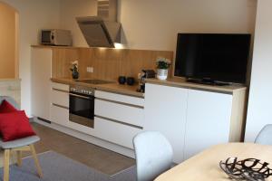 a kitchen with a tv on top of a counter at Apartment Panorama in Wagrain
