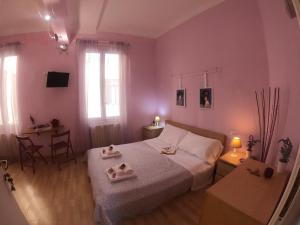 a bedroom with a bed and a table with a chair at Valerie in La Spezia