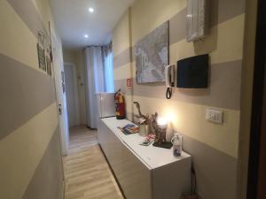 a small kitchen with a counter and a refrigerator at Valerie in La Spezia