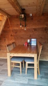 a wooden table with chairs and a laptop on it at Chalet bei der Arve in Grindelwald +26 photos
