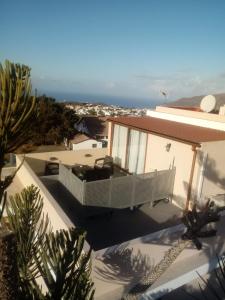 a house with a balcony and a view of the ocean at Ático Los Lomos in El Paso