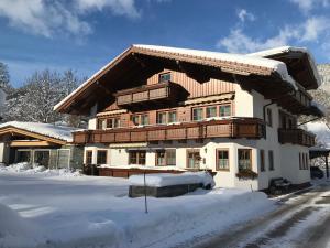 a house with snow on the ground in front of it at Appartement Kristall in Schladming