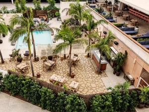an overhead view of a hotel with a pool and palm trees at Hotel June West LA, a Member of Design Hotels in Los Angeles
