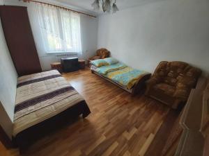 a living room with two beds and a couch at Apartament Berezka 667-108-706 in Polańczyk
