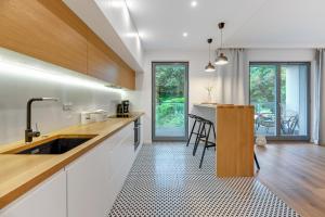 a kitchen with white cabinets and a counter top at Wave Apartments - Nadmorze 2 in Gdańsk