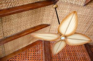 a wooden table topped with a parasol at Hotel San Pedro de Majagua in Isla Grande