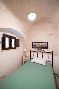 Postel nebo postele na pokoji v ubytování Trullo dal Cavaliere + 14 fotografií