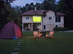 a tent and chairs in front of a house at Great Lane house in Sarajevo