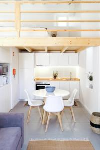 a kitchen and living room with a table and chairs at SUKHA loft at the Castle in Aljezur