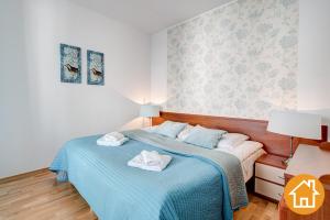 Postel nebo postele na pokoji v ubytování Apartamenty Aquamarina - visitopl