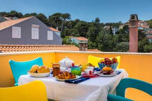 a table with breakfast food on a balcony at Apartments Priko 63 in Mali Lošinj