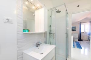 a white bathroom with a sink and a shower at Apartments Priko 63 in Mali Lošinj +27 photos
