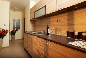 a kitchen with a sink and a bottle of wine at Stanny Court ApartHotel in Nesebar