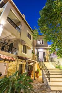 a large house with stairs in front of it at Hotel Oriana - Adults Only in Sivota