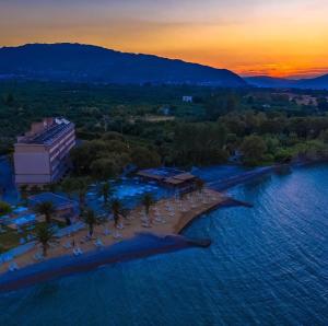 an aerial view of a resort in the ocean at sunset at Long Beach Hotel & Resort in Lóngos