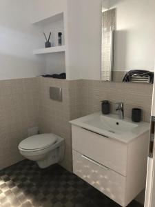 a bathroom with a toilet and a sink at Luxury Apartament Craiova Central in Craiova