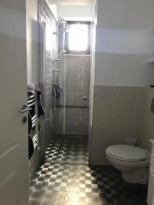 a bathroom with a toilet and a shower with a window at Luxury Apartament Craiova Central in Craiova